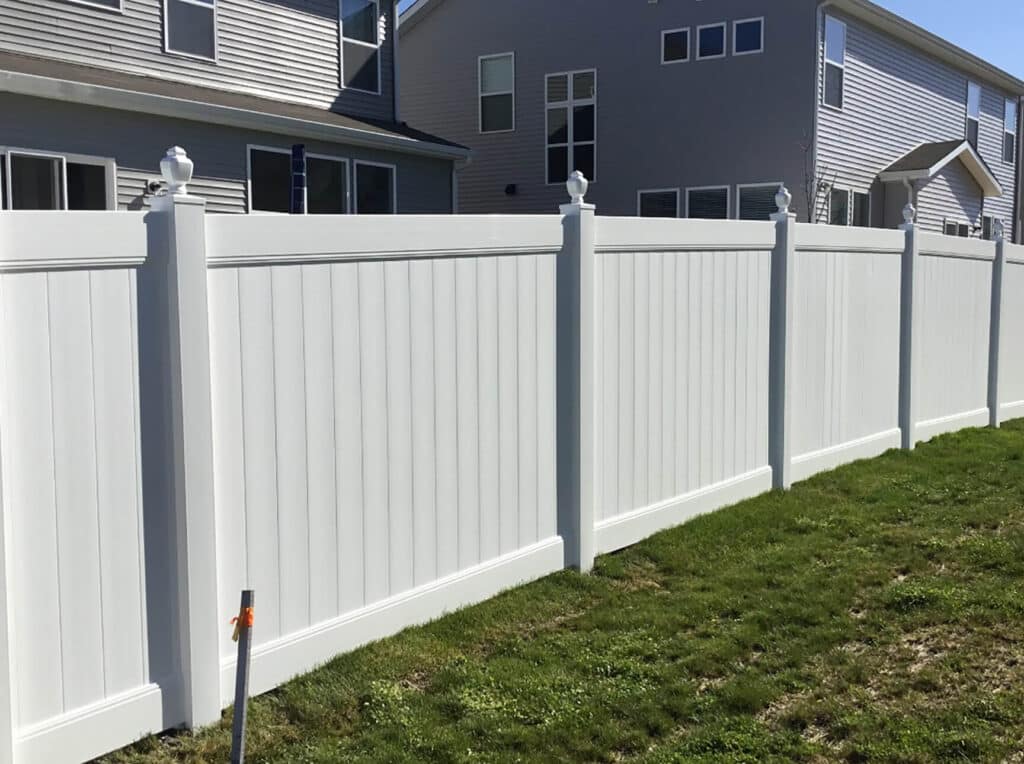 Install a vinyl privacy fence with post tops around Indianapolis